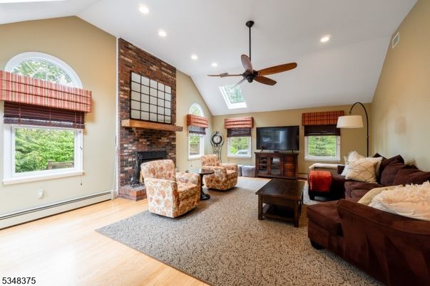 Fireplace, Interior, Living room, Recessed Lighting, Stone Walls, Wood Texture Flooring