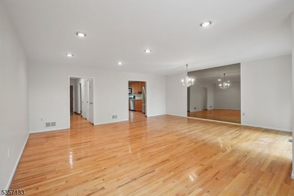 Chandelier, Empty room, Interior, Kitchen, Recessed Lighting, Stainless Steel Appliances, Wood Texture Flooring