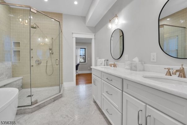 Bathroom, Dual Sink Vanities, Glass Shower, Interior, Marble, Recessed Lighting, Wood Texture Flooring