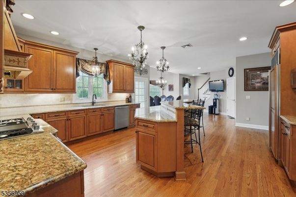 Chandelier, Dining room, Interior, Kitchen, Pendant Lights, Recessed Lighting, Stainless Steel Appliances, Wood Texture Flooring