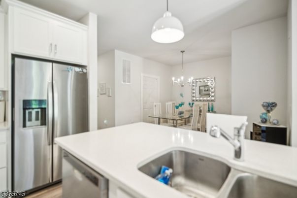 Chandelier, Dining room, Interior, Kitchen, Pendant Lights, Stainless Steel Appliances, Wood Texture Flooring