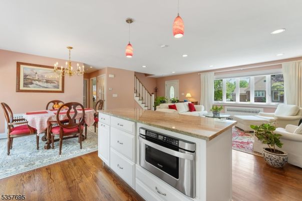 Chandelier, Dining room, Interior, Kitchen, Living room, Pendant Lights, Recessed Lighting, Stainless Steel Appliances, Wood Texture Flooring