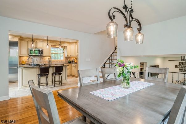 Dining room, Interior, Kitchen, Pendant Lights, Recessed Lighting, Stainless Steel Appliances, Wood Texture Flooring