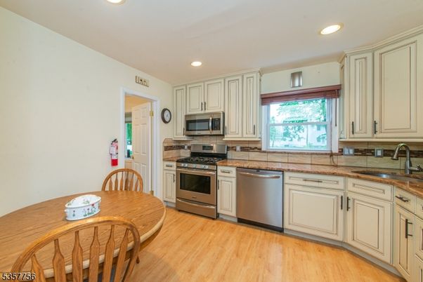 Dining room, Interior, Kitchen, Recessed Lighting, Stainless Steel Appliances, Wood Texture Flooring