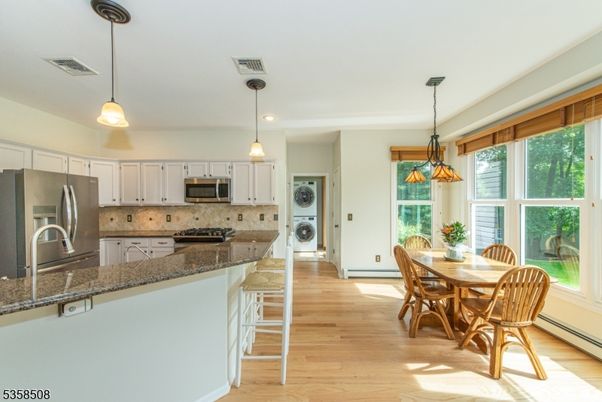Dining room, Interior, Kitchen, Pendant Lights, Recessed Lighting, Stainless Steel Appliances, Wood Texture Flooring