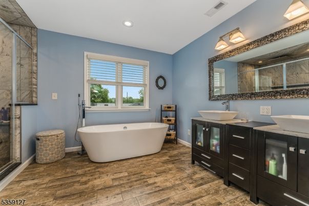 Bathroom, Dual Sink Vanities, Free Standing Baths, Interior, Recessed Lighting, Wood Texture Flooring
