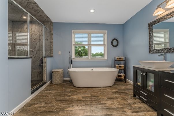 Bathroom, Free Standing Baths, Glass Shower, Interior, Marble Walls, Recessed Lighting, Wood Texture Flooring