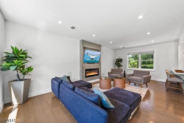 Dining room, Fireplace, Interior, Living room, Recessed Lighting, Wood Texture Flooring