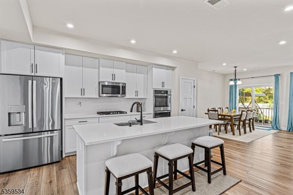 Dining room, Interior, Kitchen, Pendant Lights, Recessed Lighting, Stainless Steel Appliances, Wood Texture Flooring