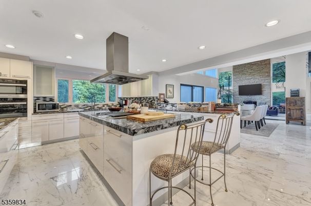Dining room, Fireplace, Interior, Kitchen, Marble, Recessed Lighting, Stainless Steel Appliances, Stone Walls