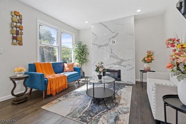 Fireplace, Interior, Living room, Marble Walls, Recessed Lighting, Wood Texture Flooring