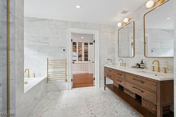 Bathroom, Dual Sink Vanities, Interior, Marble, Marble Walls, Recessed Lighting, Wood Texture Flooring