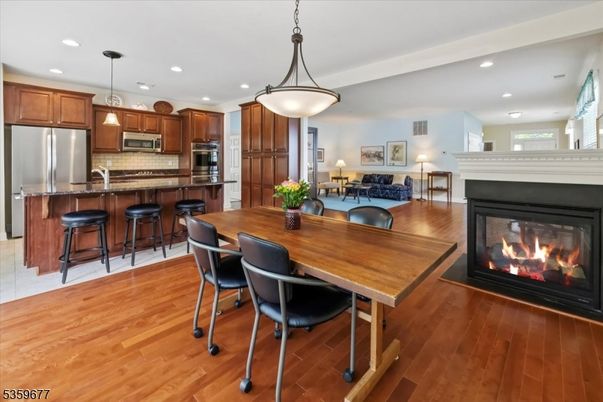 Dining room, Fireplace, Interior, Kitchen, Living room, Pendant Lights, Recessed Lighting, Stainless Steel Appliances, Wood Texture Flooring