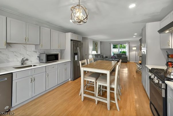 Dining room, Interior, Kitchen, Living room, Marble Walls, Pendant Lights, Recessed Lighting, Stainless Steel Appliances, Wood Texture Flooring