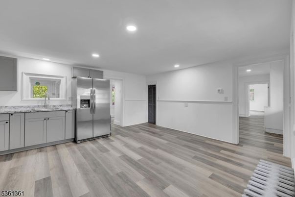 Empty room, Interior, Kitchen, Recessed Lighting, Stainless Steel Appliances, Wood Texture Flooring