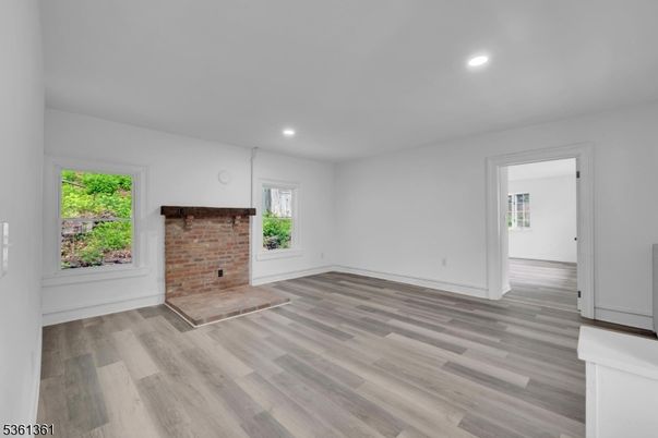 Empty room, Fireplace, Interior, Recessed Lighting, Stone Walls, Wood Texture Flooring