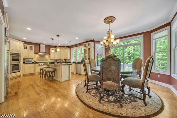 Chandelier, Dining room, Interior, Kitchen, Pendant Lights, Recessed Lighting, Stainless Steel Appliances, Wood Texture Flooring