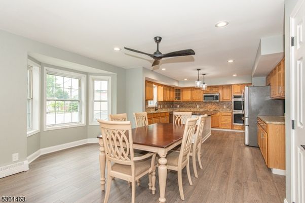 Dining room, Interior, Kitchen, Pendant Lights, Recessed Lighting, Stainless Steel Appliances, Wood Texture Flooring