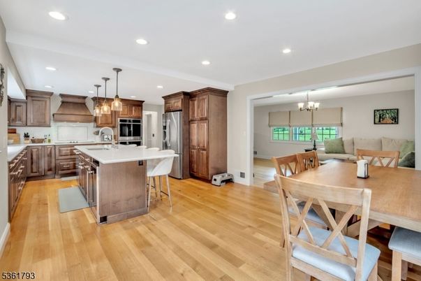 Chandelier, Dining room, Interior, Kitchen, Pendant Lights, Recessed Lighting, Stainless Steel Appliances, Wood Texture Flooring