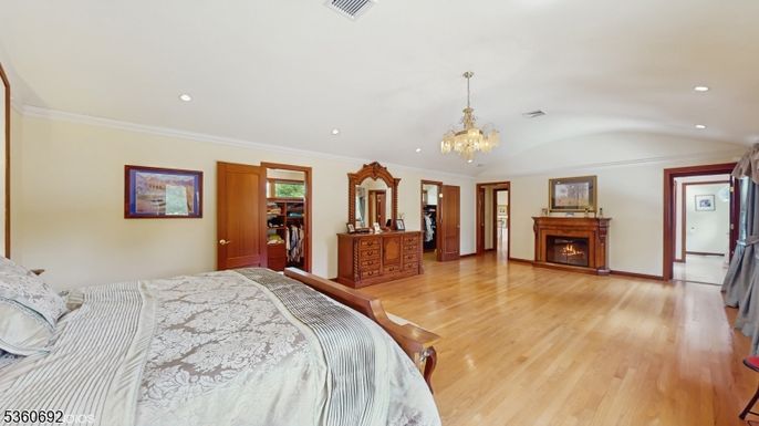 Bedroom, Chandelier, Fireplace, Interior, Recessed Lighting, Wood Texture Flooring