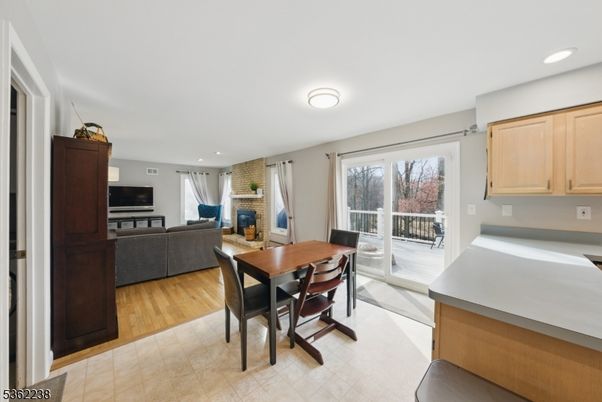 Dining room, Fireplace, Interior, Living room, Recessed Lighting, Wood Texture Flooring