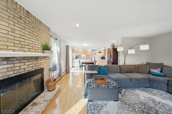 Dining room, Fireplace, Interior, Kitchen, Living room, Recessed Lighting, Stainless Steel Appliances, Stone Walls, Wood Texture Flooring