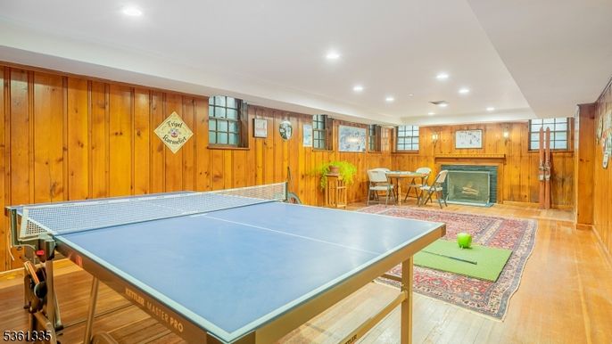 Fireplace, Game Room, Interior, Recessed Lighting, Wood Texture Flooring, Wooden Walls
