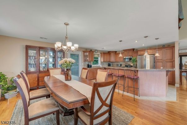 Chandelier, Dining room, Interior, Kitchen, Pendant Lights, Recessed Lighting, Stainless Steel Appliances, Wood Texture Flooring