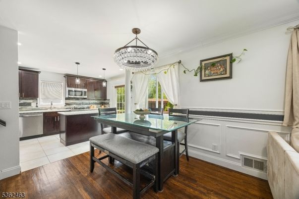 Chandelier, Dining room, Interior, Kitchen, Pendant Lights, Stainless Steel Appliances, Wood Texture Flooring