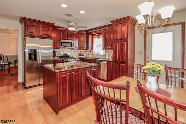 Chandelier, Dining room, Interior, Kitchen, Recessed Lighting, Stainless Steel Appliances, Wood Texture Flooring