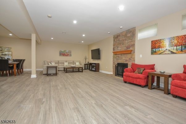 Dining room, Fireplace, Interior, Living room, Recessed Lighting, Stone Walls, Wood Texture Flooring