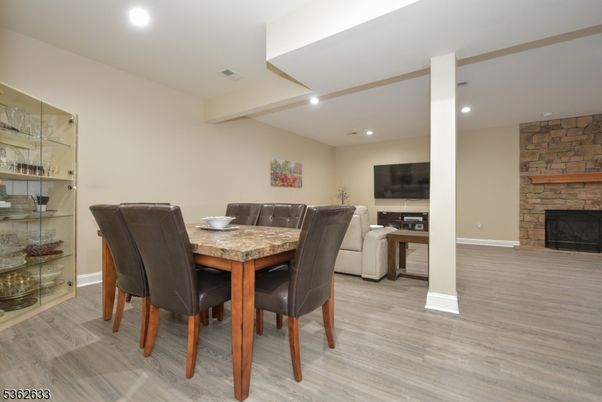 Dining room, Fireplace, Interior, Recessed Lighting, Stone Walls, Wood Texture Flooring