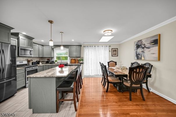 Dining room, Interior, Kitchen, Pendant Lights, Recessed Lighting, Stainless Steel Appliances, Wood Texture Flooring