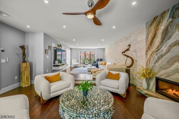 Dining room, Fireplace, Interior, Living room, Recessed Lighting, Stone Walls, Wood Texture Flooring