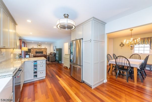 Chandelier, Dining room, Fireplace, Interior, Kitchen, Recessed Lighting, Stainless Steel Appliances, Wood Texture Flooring