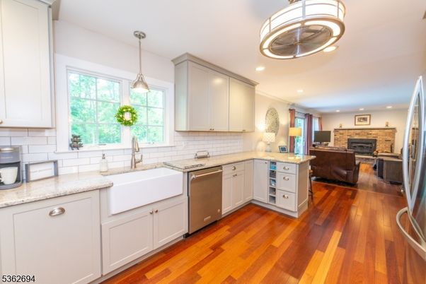 Fireplace, Interior, Kitchen, Living room, Pendant Lights, Recessed Lighting, Stainless Steel Appliances, Stone Walls, Wood Texture Flooring