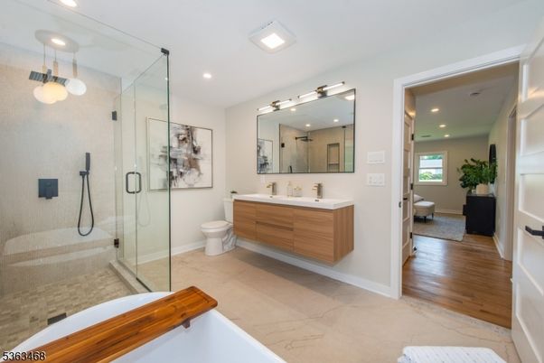 Bathroom, Dual Sink Vanities, Free Standing Baths, Glass Shower, Interior, Marble, Recessed Lighting, Wood Texture Flooring