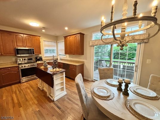 Chandelier, Dining room, Interior, Kitchen, Recessed Lighting, Stainless Steel Appliances, Wood Texture Flooring