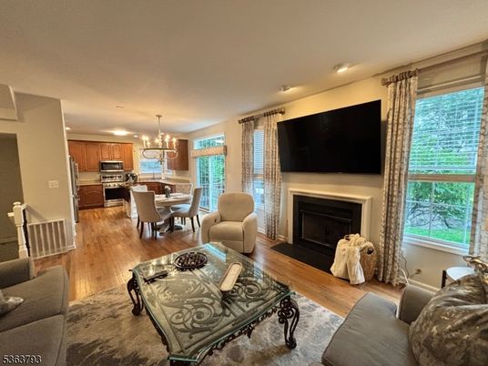 Chandelier, Dining room, Fireplace, Interior, Kitchen, Living room, Recessed Lighting, Stainless Steel Appliances, Wood Texture Flooring