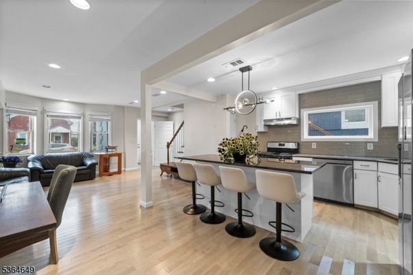 Dining room, Interior, Kitchen, Living room, Pendant Lights, Recessed Lighting, Stainless Steel Appliances, Wood Texture Flooring
