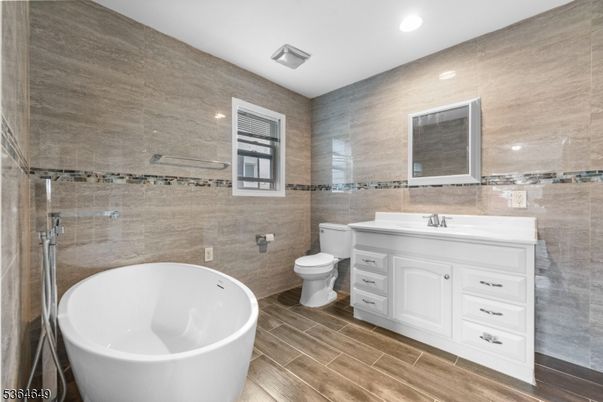 Bathroom, Dual Sink Vanities, Free Standing Baths, Glass Shower, Interior, Recessed Lighting, Wood Texture Flooring