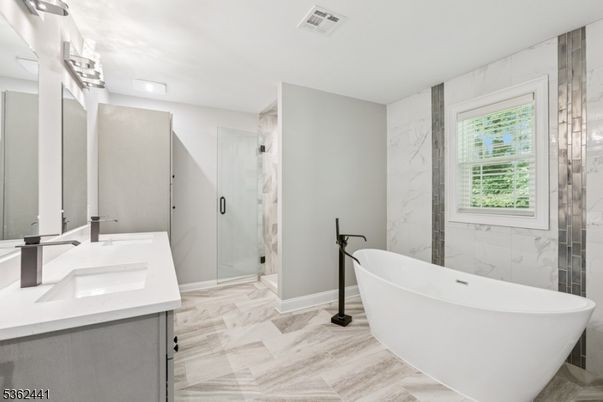 Bathroom, Dual Sink Vanities, Free Standing Baths, Glass Shower, Interior, Marble, Marble Walls, Wood Texture Flooring