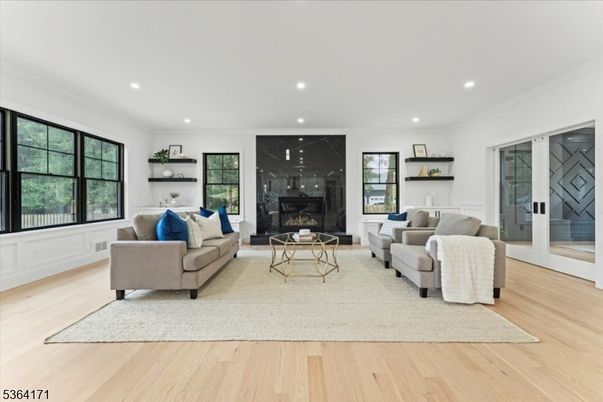 Fireplace, Interior, Living room, Marble Walls, Recessed Lighting, Wood Texture Flooring