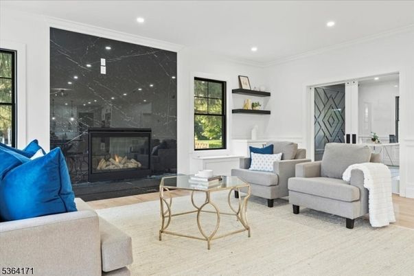 Fireplace, Interior, Living room, Marble Walls, Recessed Lighting, Wood Texture Flooring