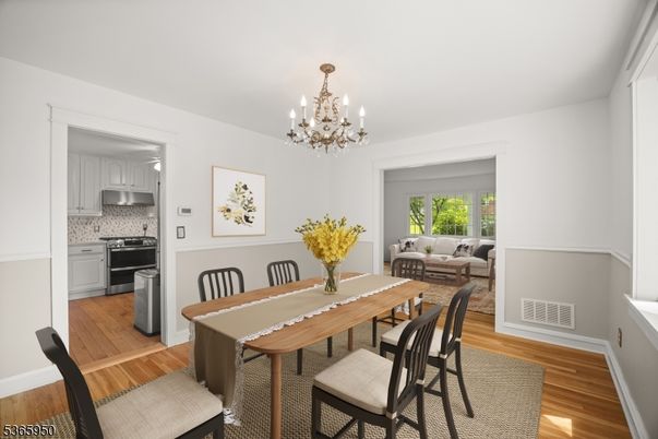Chandelier, Dining room, Interior, Kitchen, Living room, Stainless Steel Appliances, Wood Texture Flooring