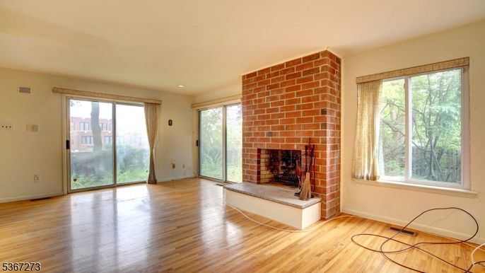 Empty room, Fireplace, Interior, Recessed Lighting, Stone Walls, Wood Texture Flooring