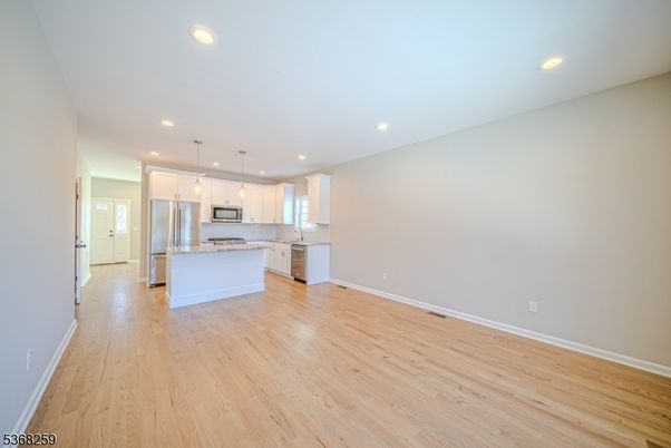 Empty room, Interior, Kitchen, Pendant Lights, Recessed Lighting, Stainless Steel Appliances, Wood Texture Flooring