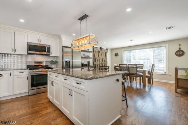 Dining room, Interior, Kitchen, Pendant Lights, Recessed Lighting, Stainless Steel Appliances, Wood Texture Flooring