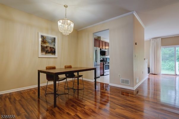 Chandelier, Dining room, Interior, Kitchen, Stainless Steel Appliances, Wood Texture Flooring