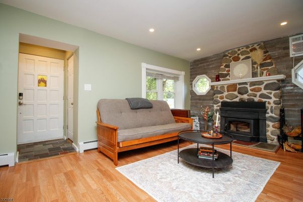 Fireplace, Interior, Living room, Recessed Lighting, Stone Walls, Wood Texture Flooring